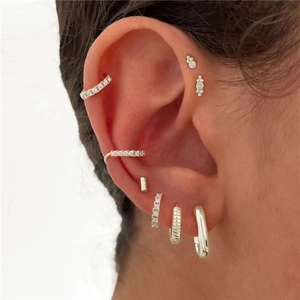 Close-up of S925 silver ear cuff and stud set with cubic zirconia on female model ear