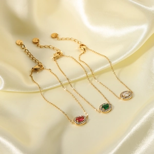 Elegant 18K gold-plated stainless steel bracelets with zircon hearts on beige satin fabric