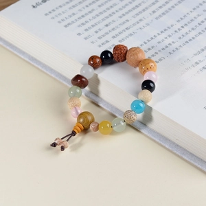 Macro detail of Buddhist prayer beads with diverse natural stones on an open book