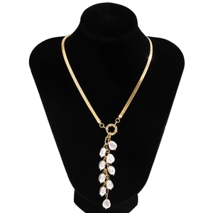 Baroque golden flat snake chain necklace with pearl tassel pendant on black bust display