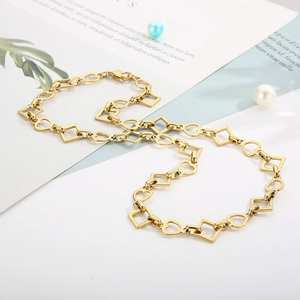 Detail of gold-plated chain featuring alternating heart and square geometric links