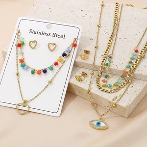Detailed view of layered stainless steel evil eye necklace with colorful beads on stone