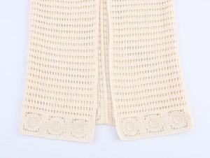Detailed close-up of apricot hollow knit vest with floral crochet hem and mesh texture