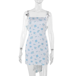 Detail of white slim fit mini dress featuring light blue floral patterns and bow straps