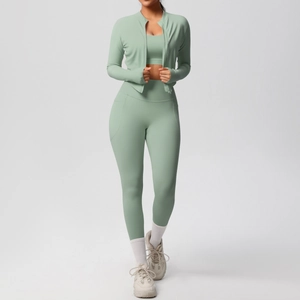 Detailed view of light sage green three-piece yoga set with jacket, bra and leggings