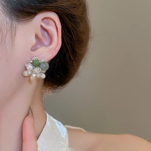 Detailed view of floral stud earring with green agate beads and freshwater pearl