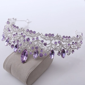 Detail of luxury bridal tiara featuring purple teardrop crystals and silver flower settings