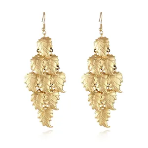 Detailed view of layered leaf tassel earrings with gold finish and vein texture