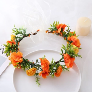Detailed view of orange silk floral headband with delicate white tulle bridal veil