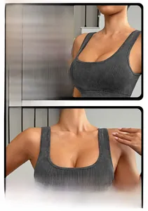Detail of wide shoulder straps and ribbed fabric on a charcoal grey sports bra