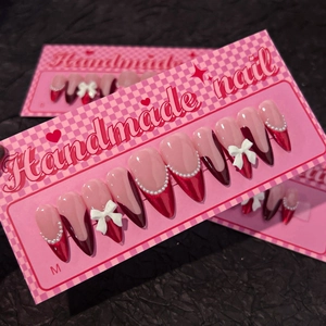 Handmade red French almond press-on nails with 3D bows and pearl accents in size M