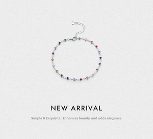 Macro shot of silver bracelet featuring colorful round faceted stones and adjustable clasp