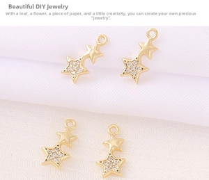 Detailed view of two linked gold star pendants with micro-pave crystals for DIY jewelry