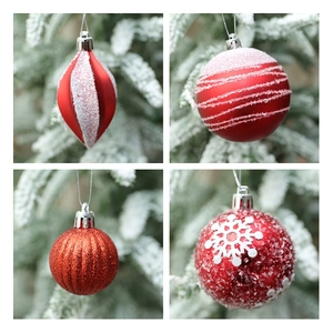 Detail view of red Christmas ball ornaments with glitter snowflakes and varied textures