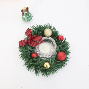 Mini Christmas wreath with pine needles, red gold balls, and plaid bow on white background