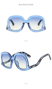 Detail of blue wavy frame sunglasses with gradient lenses and tortoiseshell temples