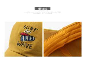 Detail shot of multi-color SURF WAVE embroidery on yellow washed cotton baseball cap