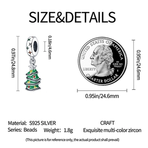 S925 silver Christmas tree charm with colorful zircons next to a coin for size reference
