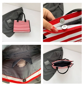 Detail view of red striped canvas tote showing magnetic closure and interior pocket