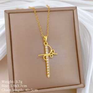 Macro shot of gold cross pendant with crystals in jewelry box on white silk cloth