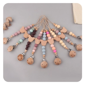 Detail of colorful silicone beads and beech wood bear clip for baby pacifier chain