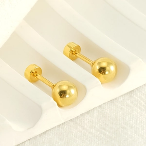 Polished 18K gold ball stud earrings with screw-back closures on a white display stand