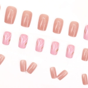 Press-on nails in nude pink and white marble waves with gold foil accents