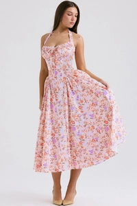 Detail of floral halter neck dress featuring pink patterns and adjustable tie front