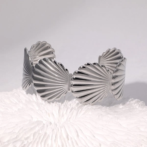 Scallop shell link open bangle in polished silver stainless steel on coral decor