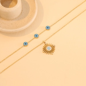 Gold double-layer evil eye necklace with sun pendant and sparkling blue gems