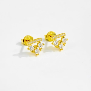 Detailed close-up showing S925 silver hallmark and zircons on gold stud earrings