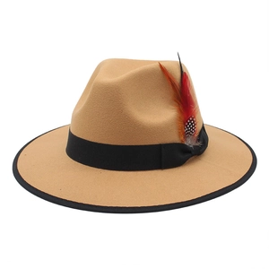 Close-up of camel wool fedora hat featuring classic black ribbon and decorative feathers