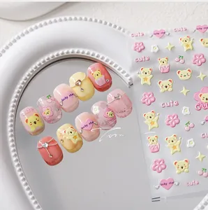 Detailed 5D embossed nail stickers featuring cute yellow bears, pink flowers, and stars