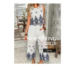 Detailed view of dark blue hollow floral embroidery on white sleeveless top and pants