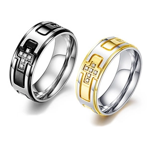 Detailed close-up of stainless steel rings with black and gold cross inlay designs