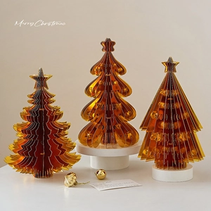 Three-piece set of golden translucent origami Christmas trees with star tree toppers