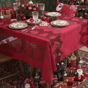 Festive red Christmas lace tablecloth with bell and bow patterns for holiday dining table decor