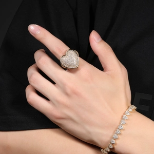 Detail of hip-hop golden heart ring and bracelet with full 3A zircon micro-paving