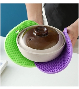 Detail of round honeycomb silicone trivets holding a hot pot for heat protection