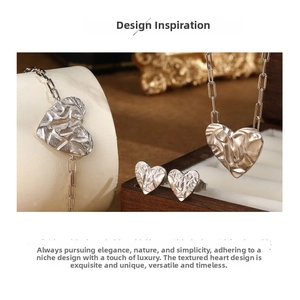 Detailed view of sterling silver heart jewelry set with unique textured artistic finish