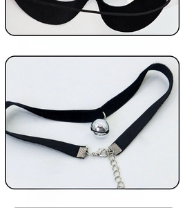 Detail of black velvet choker with silver bell and adjustable elastic mask strap