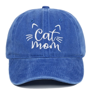 Macro detail of Cat Mom embroidery on blue washed vintage denim baseball cap fabric