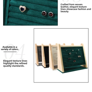 Macro shot of velvet jewelry display stands with wooden frames for rings and earrings