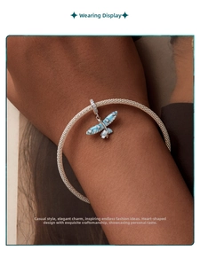 Detailed view of an S925 silver mesh bracelet with blue opal butterfly charm on wrist