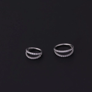 Macro detail of silver stainless steel hoops with double-row micro-pave cubic zirconia stones