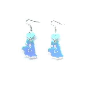 Detailed view of blue acrylic ghost earrings with iridescent finish and candy heart accents