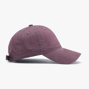 Classic washed purple baseball cap with letter embroidery and curved brim in side view