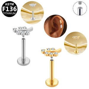 Detail of G23 titanium moon and star labret studs with cubic zirconia and screw thread