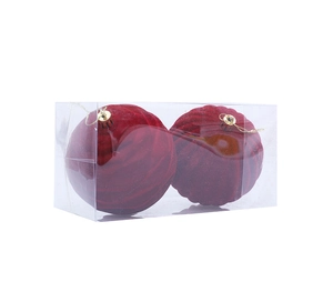 Detail of two dark red flocked Christmas ball ornaments with spiral texture in plastic box