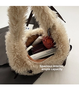 Spacious interior of beige plush shoulder bag showing room for umbrella and wallet